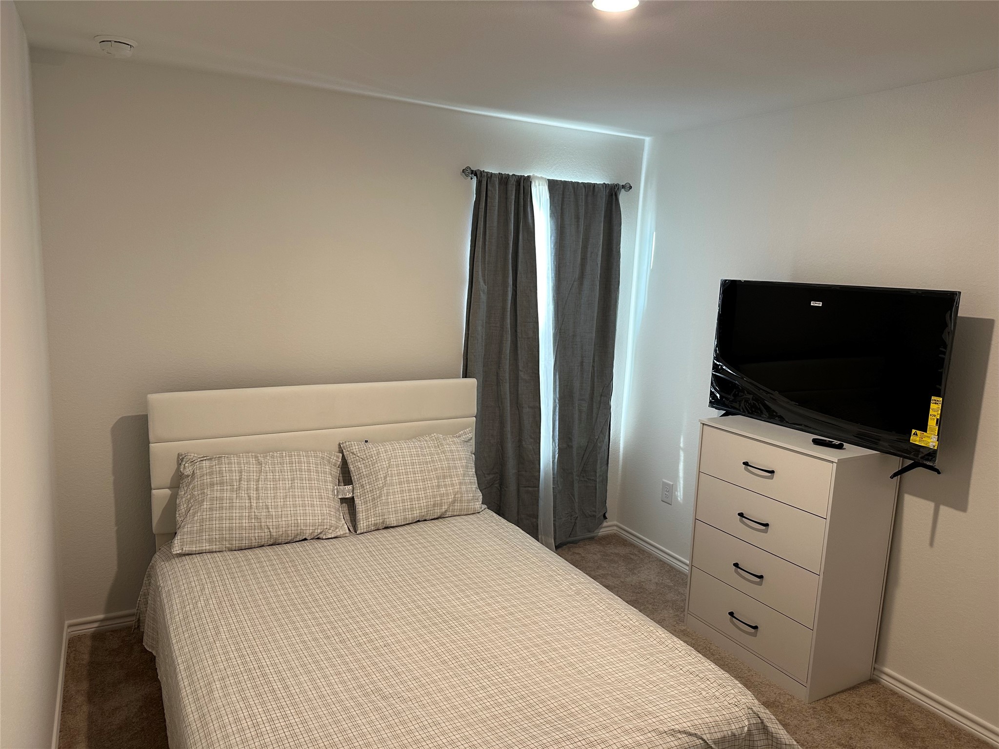 15214 Canyon Rapids Road Conroe, TX 77302 - Photo 15 of 22 a bedroom with a bed and a flat screen tv