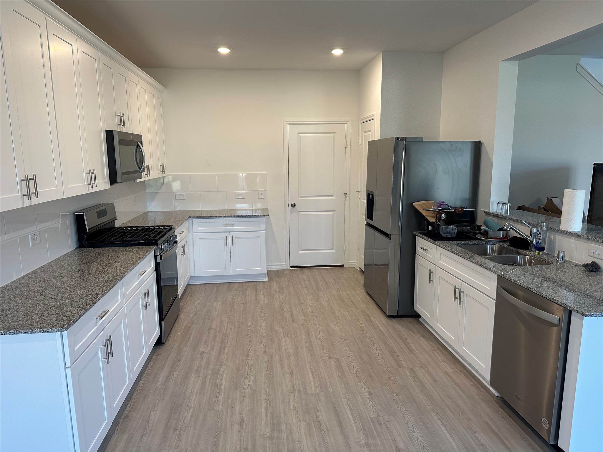 15214 Canyon Rapids Road Conroe, TX 77302 - Photo 5 of 22 a kitchen with a sink stove top oven and refrigerator