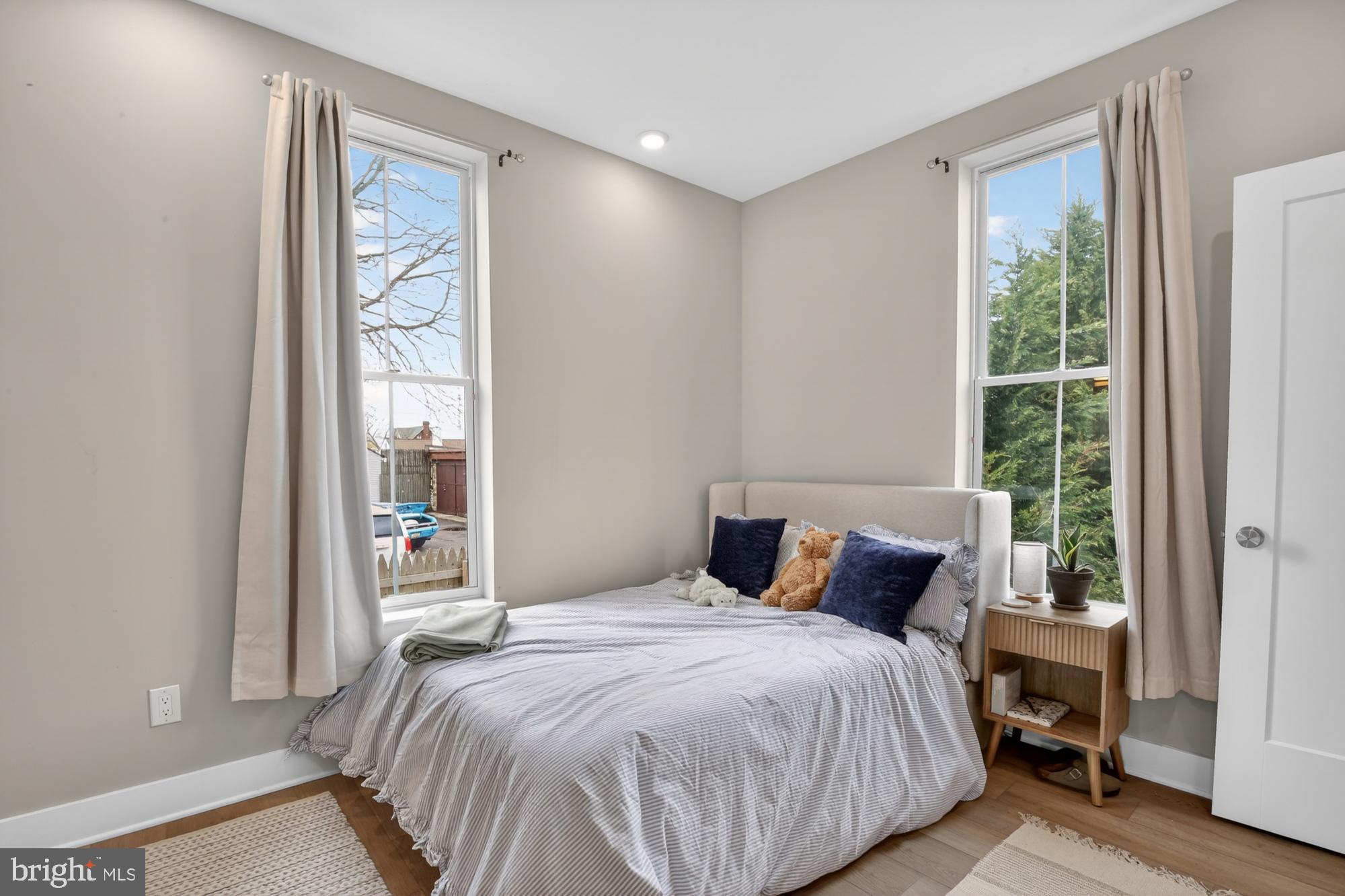 6712 Ridge Avenue, Unit 203 Philadelphia, PA 19128 - Photo 10 of 16 a bedroom with a bed and a window