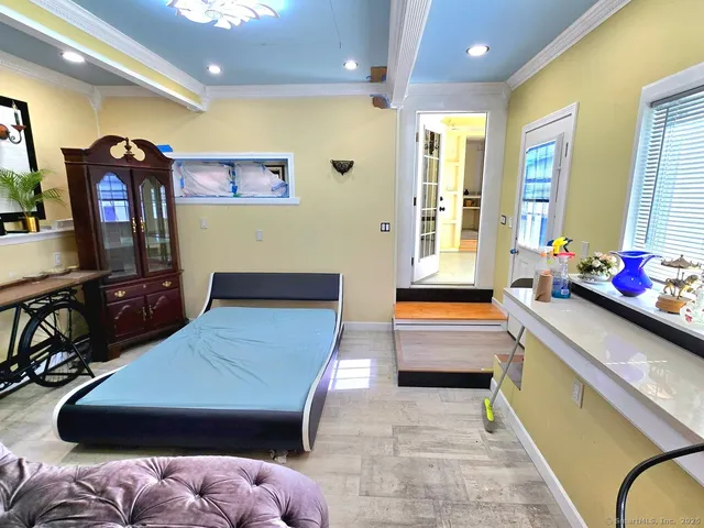 a room with furniture pool table flat screen tv and windows