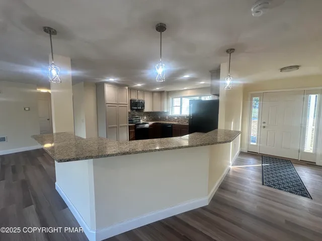 a kitchen with stainless steel appliances granite countertop a sink and a stove