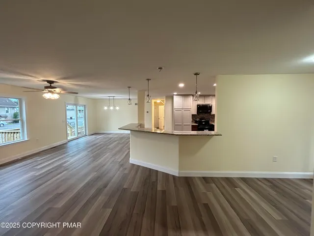 a view of small space with wooden floor and windows