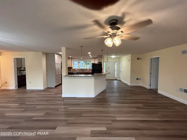a bathroom with a sink vanity and a toilet