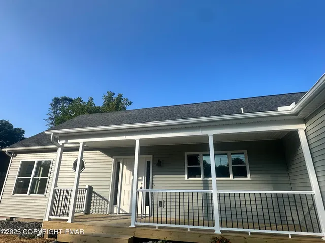 a large kitchen with stainless steel appliances kitchen island a large counter top and a wooden floors