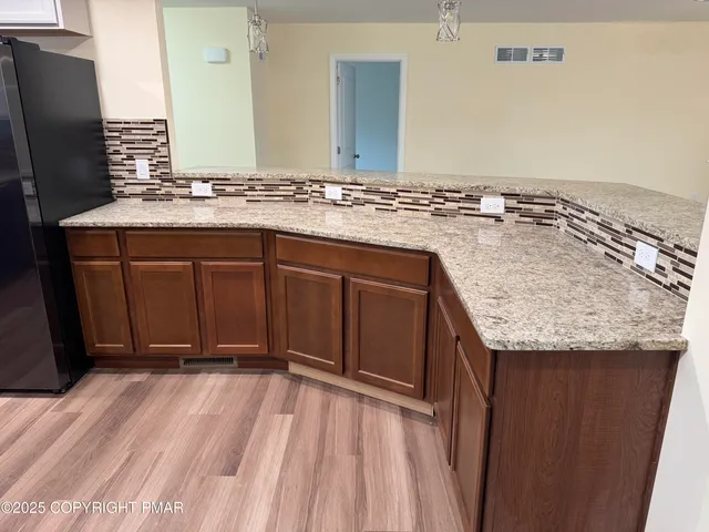 a view of an empty room and wooden floor