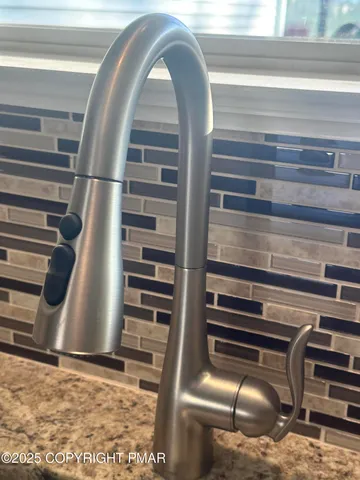 an empty room with wooden floor closet and windows