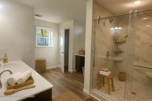 a bathroom with a glass shower door