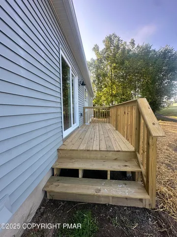a view of an empty room with kitchen and kitchen view