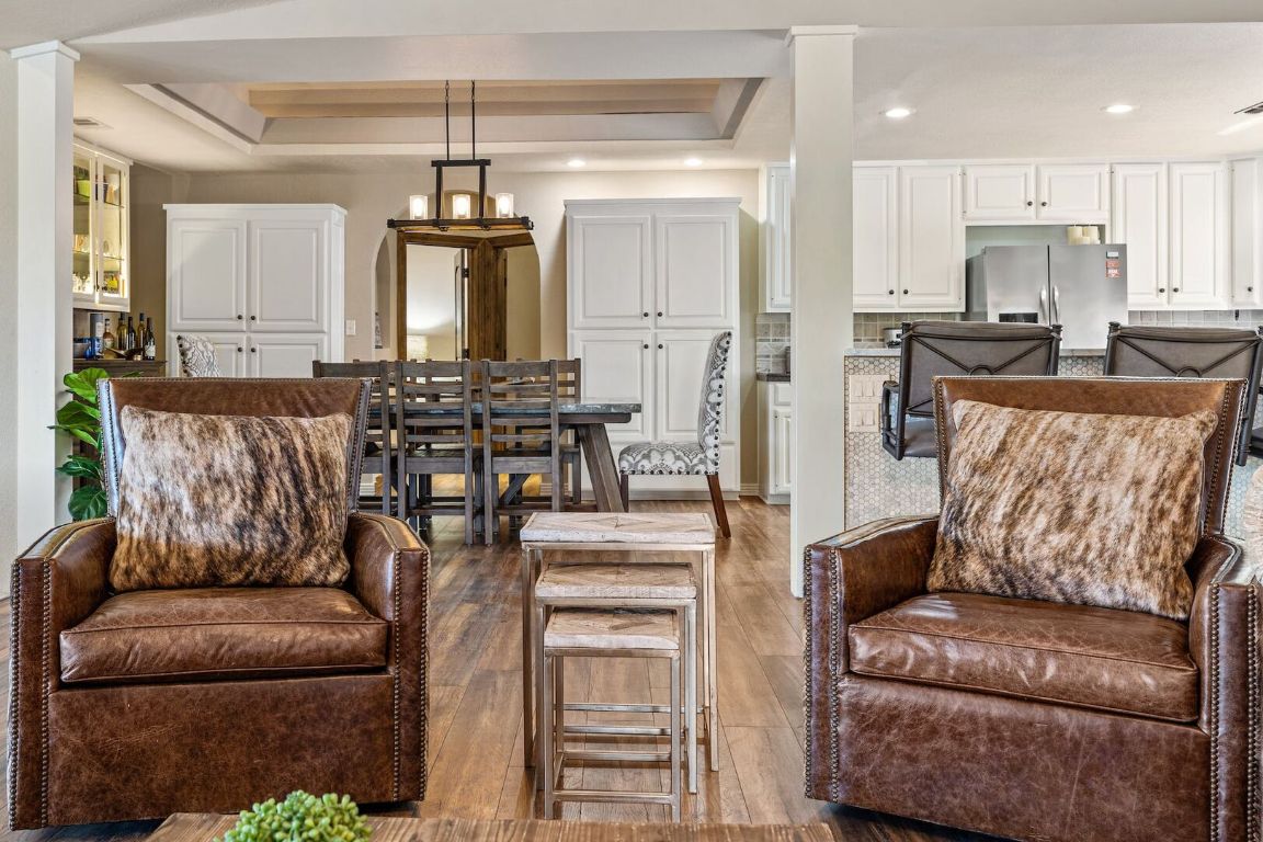 925 Challenger Lakeway, TX 78734 - Photo 12 of 40 a living room with furniture a chandelier and kitchen view