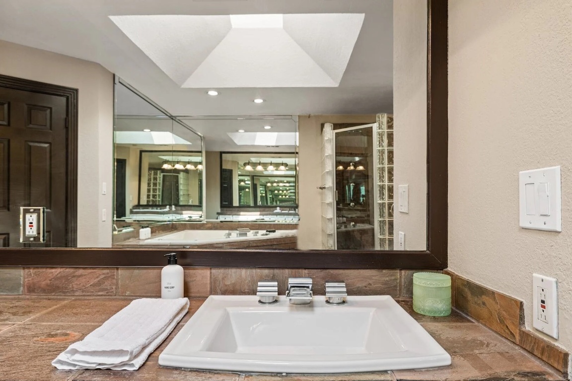 925 Challenger Lakeway, TX 78734 - Photo 22 of 40 a bathroom with a sink and a mirror