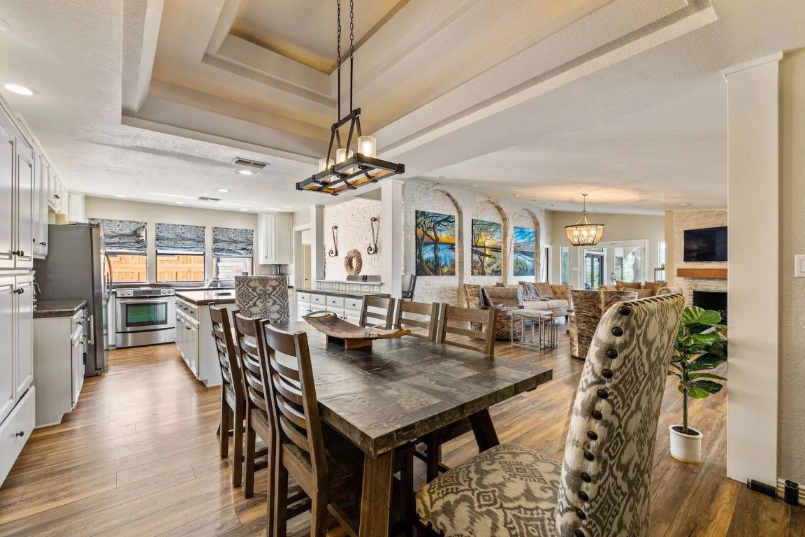 925 Challenger Lakeway, TX 78734 - Photo 9 of 40 a view of a dining room with furniture and wooden floor
