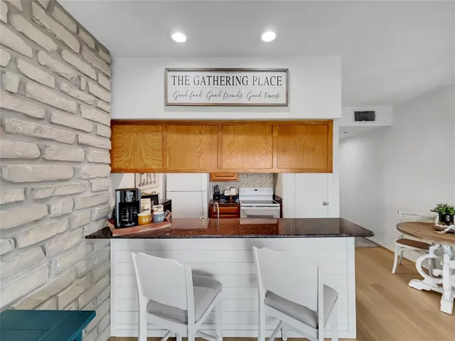 a view of kitchen with a sink and a refrigerator