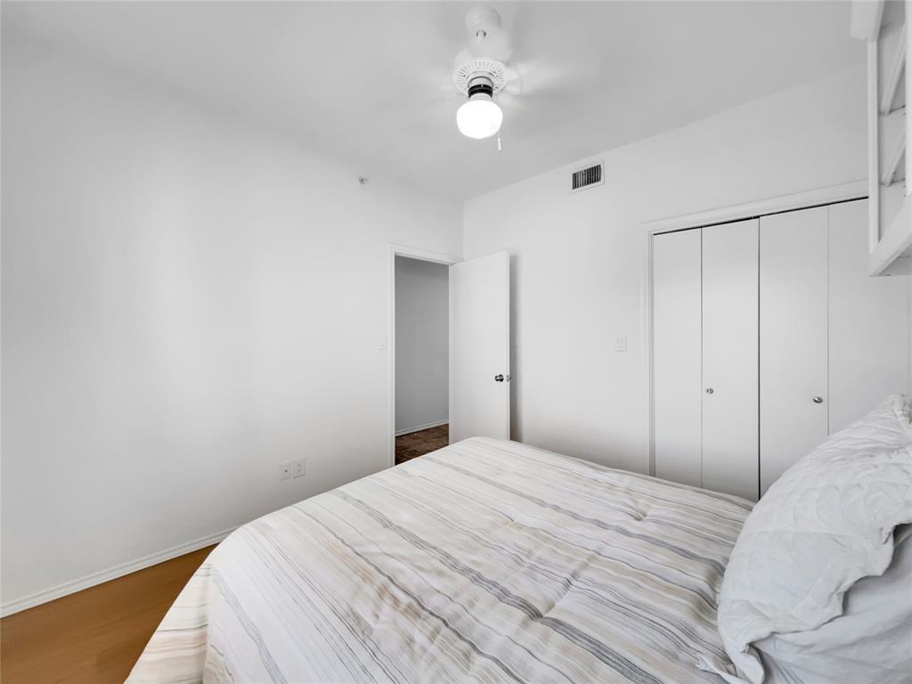 401 East Pearl Street, Unit 2307 Granbury, TX 76048 - Photo 14 of 21 a bedroom with a bed and a ceiling fan