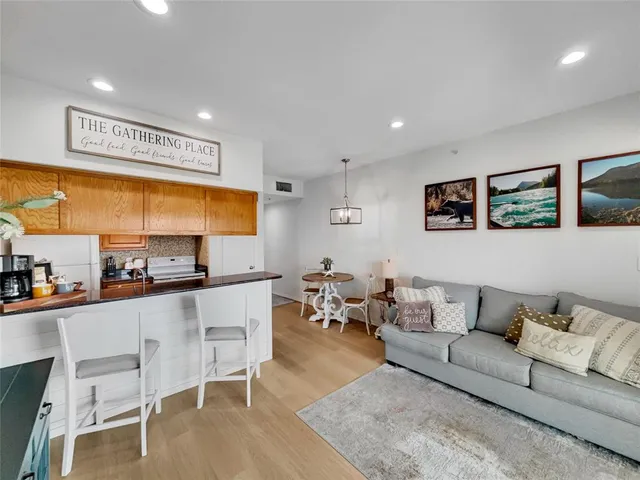a living room with furniture and kitchen view