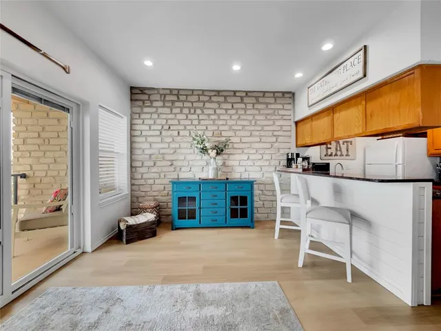 a living room with a fireplace furniture a rug and a window