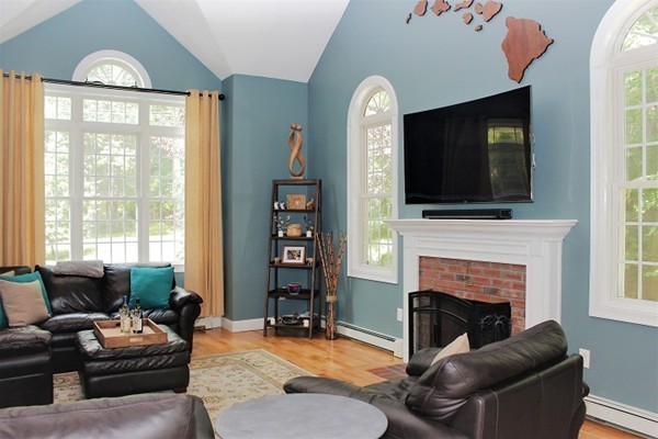 301 Union Street Hanover, MA 02339 - Photo 12 of 30 a living room with furniture a fireplace and a flat screen tv