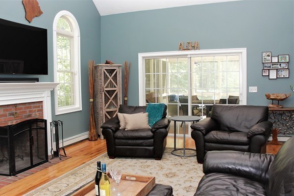 301 Union Street Hanover, MA 02339 - Photo 13 of 30 a living room with furniture a flat screen tv and a fireplace