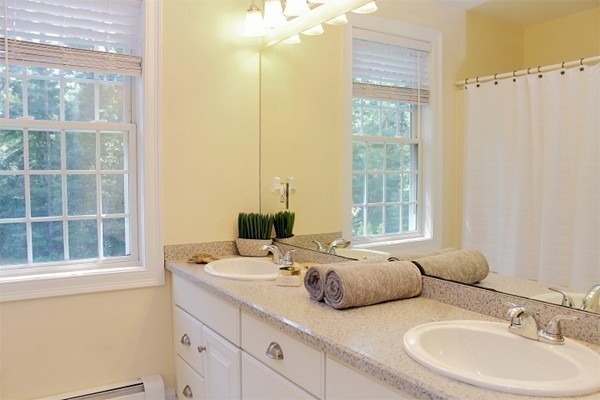 301 Union Street Hanover, MA 02339 - Photo 24 of 30 a bathroom with double vanity and a window