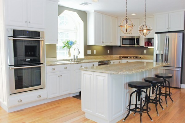 301 Union Street Hanover, MA 02339 - Photo 5 of 30 a kitchen with stainless steel appliances granite countertop a stove a sink and a microwave
