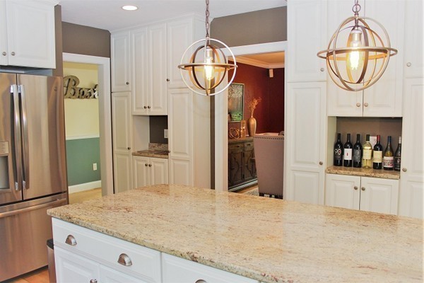 301 Union Street Hanover, MA 02339 - Photo 6 of 30 a kitchen with stainless steel appliances granite countertop a refrigerator a stove and a wooden floors