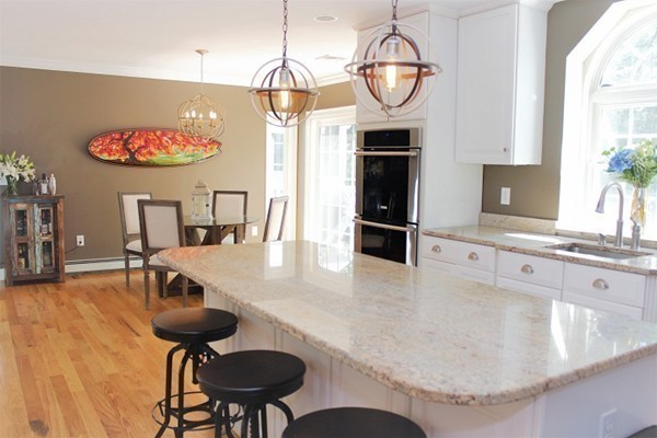301 Union Street Hanover, MA 02339 - Photo 7 of 30 a view of a dining room with furniture a chandelier and wooden floor
