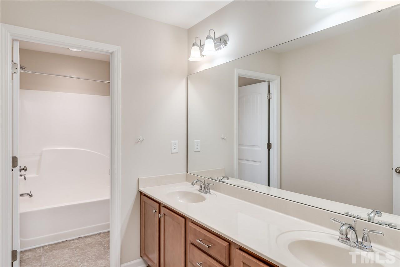 2443 Memory Ridge Drive Raleigh, NC 27606 - Photo 22 of 28 a bathroom with a sink and a mirror