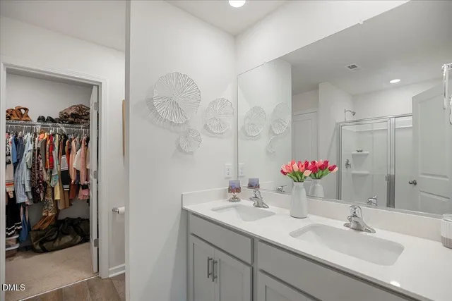 a view of walk in closet with clothes