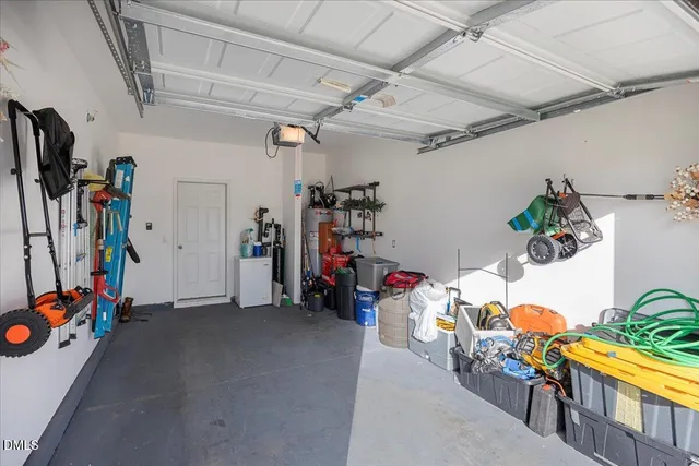 a view of a patio with table and chairs and a barbeque