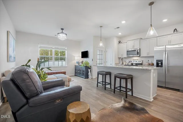 a living room with furniture and kitchen view
