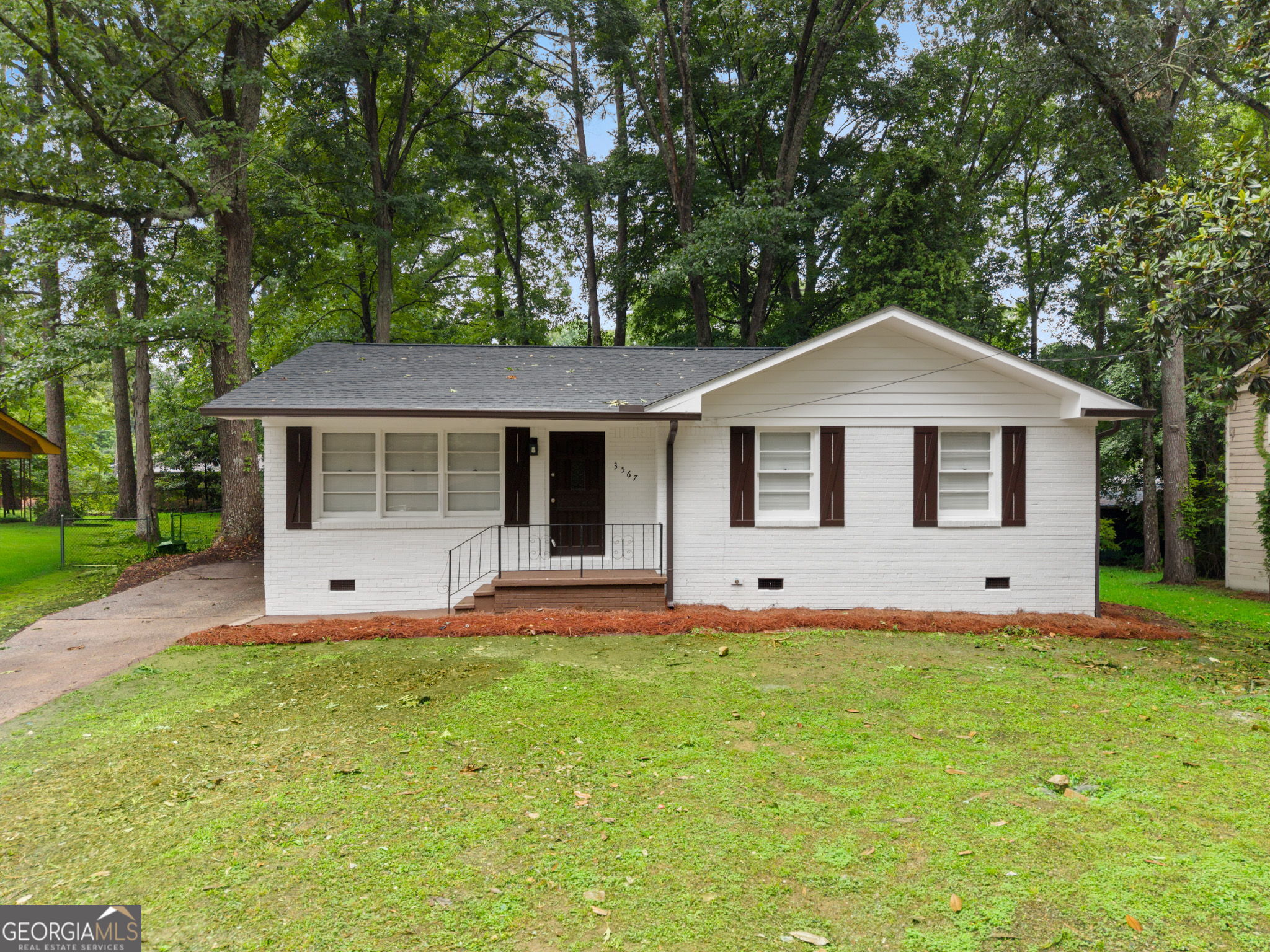 3567 Forrest Park Road Southeast Atlanta, GA 30354 - Photo 1 of 29 a front view of a house with a yard and garage