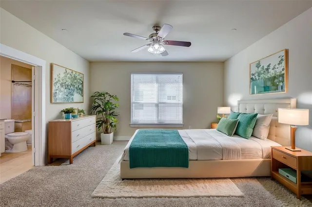 a bedroom with a large bed and a chandelier