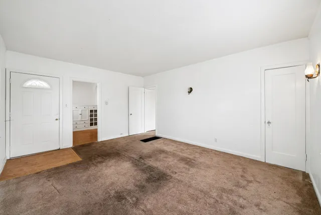 a kitchen with a refrigerator a stove top oven a sink and cabinets