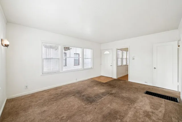 a kitchen with granite countertop white cabinets and sink