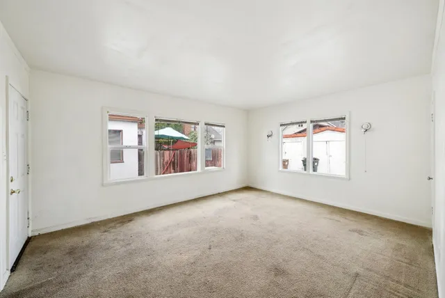 a kitchen with stainless steel appliances a stove and white cabinets
