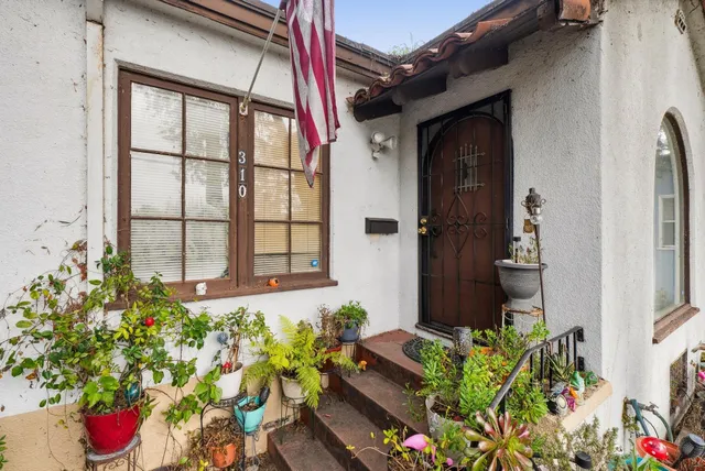 a view of a house with wooden fence