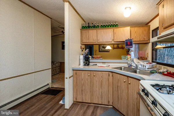 a kitchen with a sink appliances and cabinets