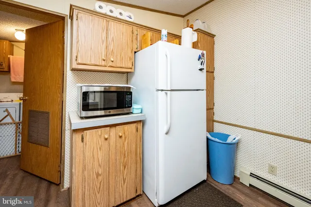 a white refrigerator freezer sitting in a kitchen