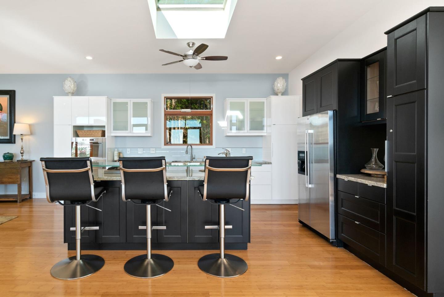 116 New Brighton Road Aptos, CA 95003 - Photo 21 of 50 a kitchen with stainless steel appliances wooden floor dining table and chairs
