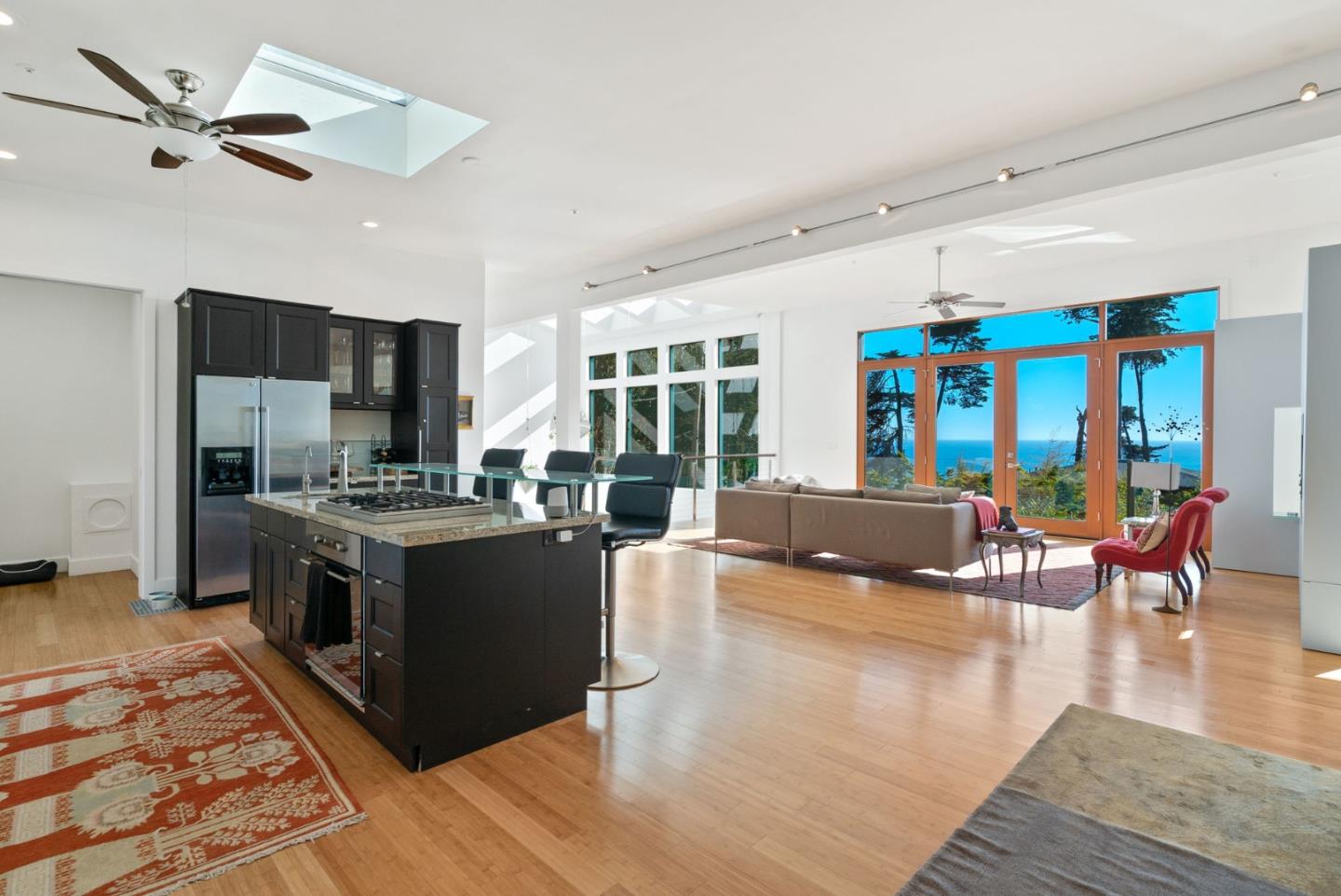 116 New Brighton Road Aptos, CA 95003 - Photo 28 of 50 a large living room with stainless steel appliances granite countertop couches a fireplace a flat screen tv and a dining table with the kitchen view