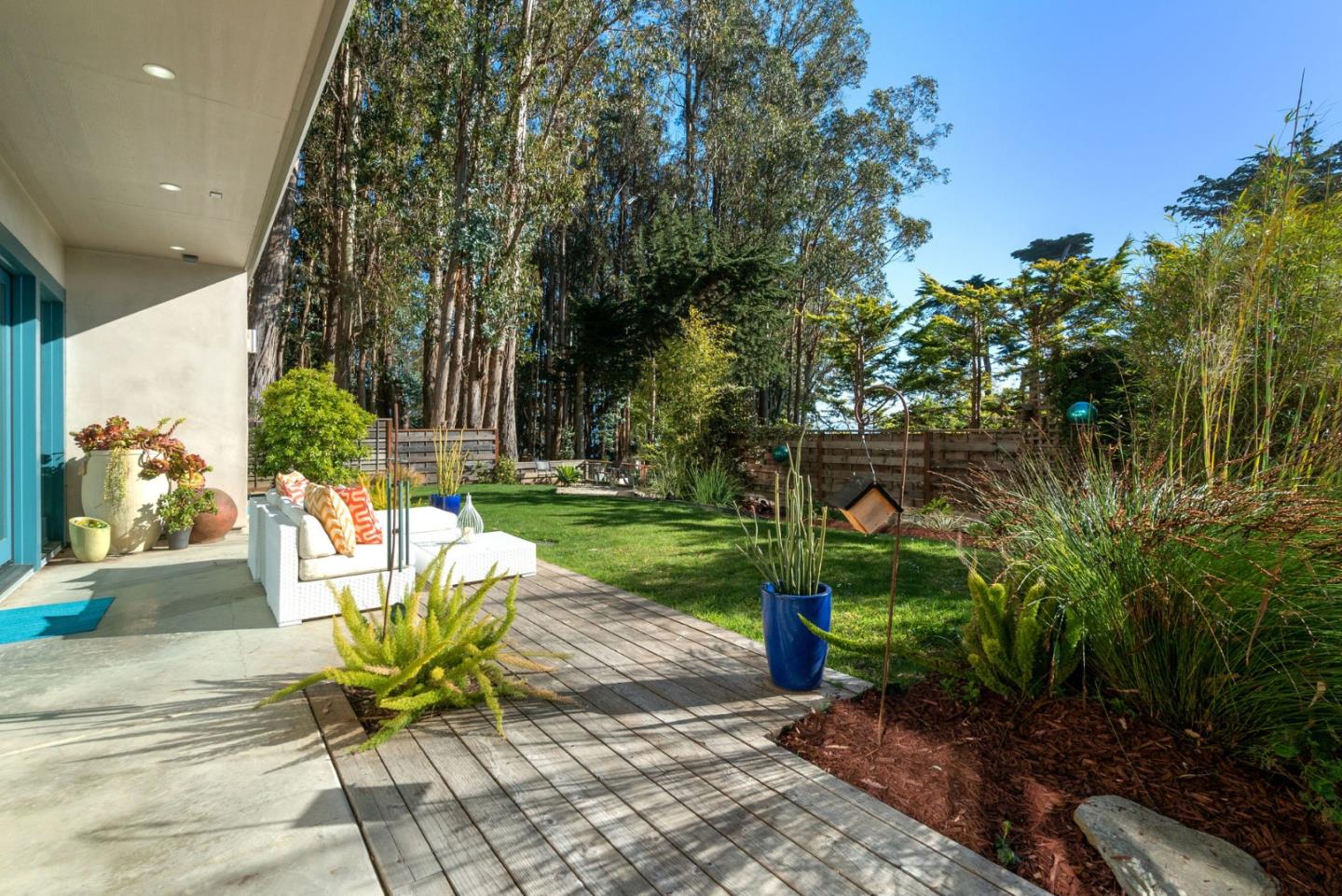 116 New Brighton Road Aptos, CA 95003 - Photo 5 of 50 a chair and table sitting in backyard of house
