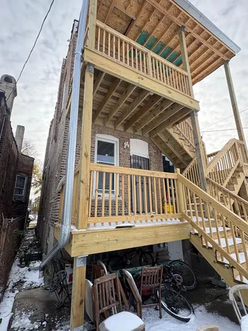 a view of a small house with roof deck