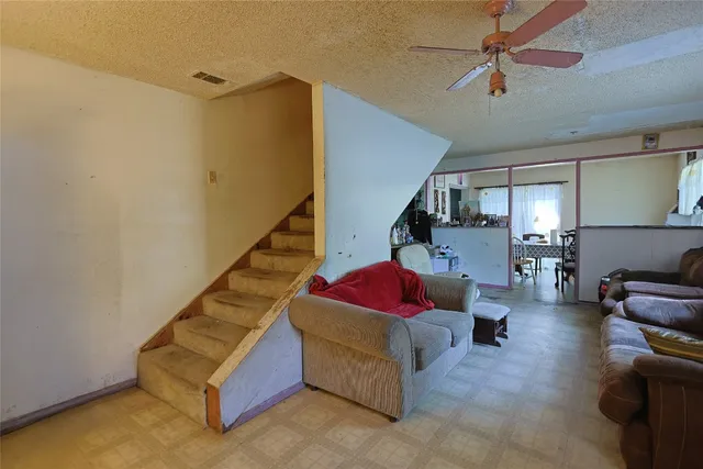 a living room with furniture and stairs