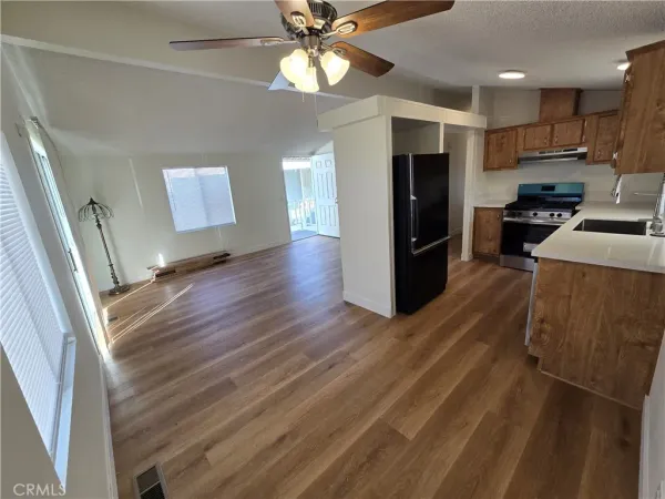 a kitchen with stainless steel appliances granite countertop a refrigerator and a stove top oven