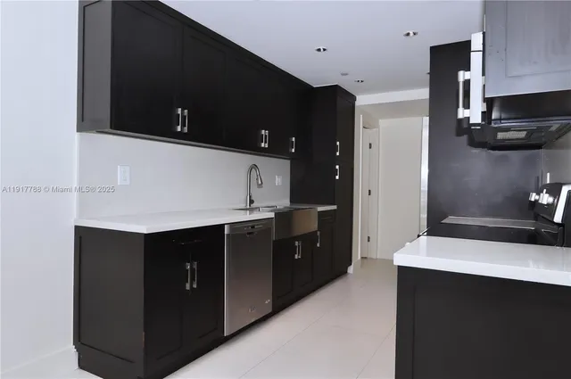 a kitchen with a sink and cabinets