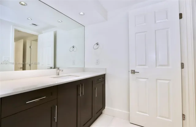 a bathroom with a double vanity sink and mirror