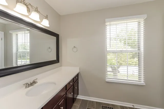 a bathroom with a sink a mirror and a bathtub