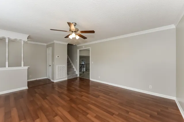 a view of an empty room with wooden floor