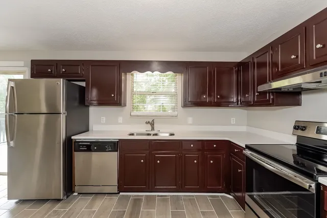 a kitchen with a sink appliances and cabinets