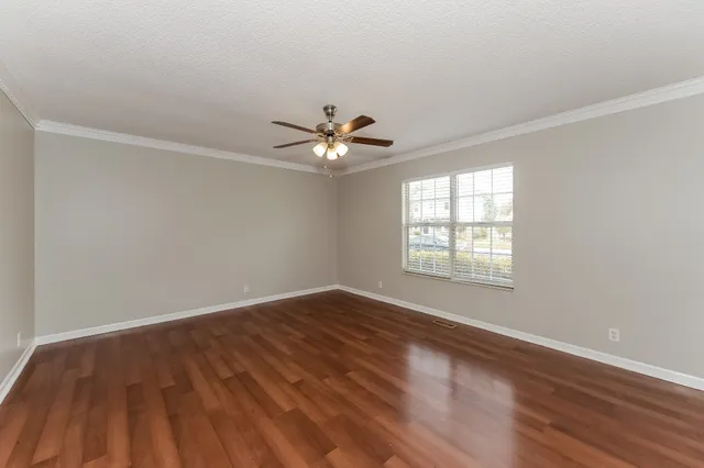 wooden floor in an empty room with a window