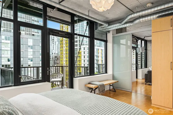 a bedroom with furniture and large windows